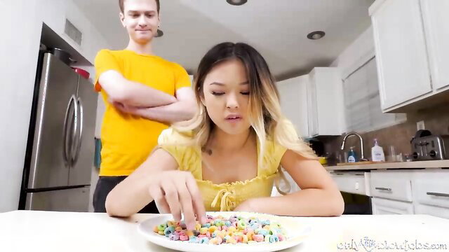 Lulu Chu eating cereal with stepbro behind in kitchen