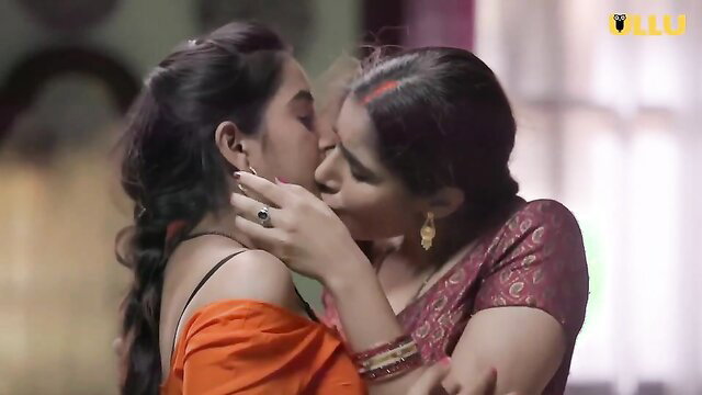 Two Indian women in sarees passionately kissing, lesbian embrace