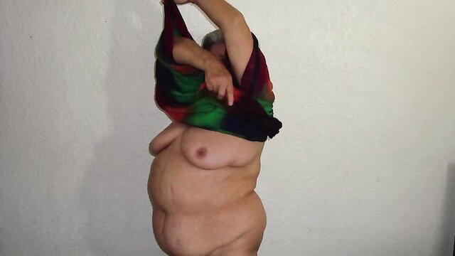 Old nasty hairy granny lifting colorful shawl, exposing saggy tits and belly