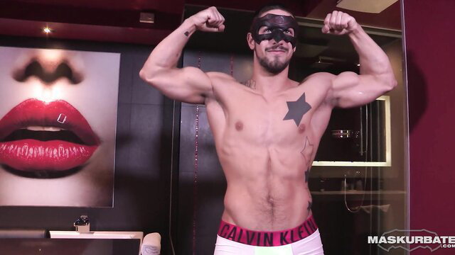 Muscular masked hunk flexing abs in Calvin Klein briefs on Halloween night