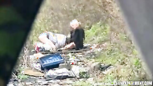 Kinky blonde slut exposed in public, surrounded by guys and gear