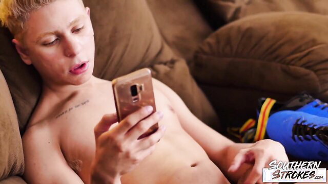 Blond skinny twink stroking cock on boyfriend's clothes while watched