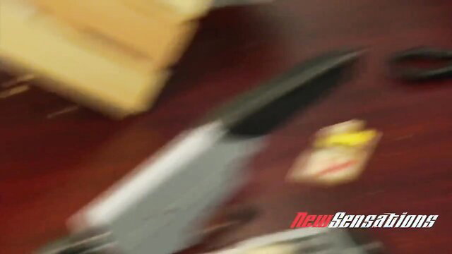 Blurry office desk with knife, mousetrap and NewSensations logo