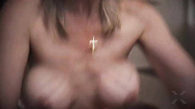 Blonde Lilly James topless with gold cross necklace on massive tits