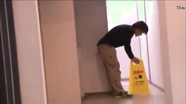 Japanese guy bending over with wet floor sign exposing ass in JAV prank