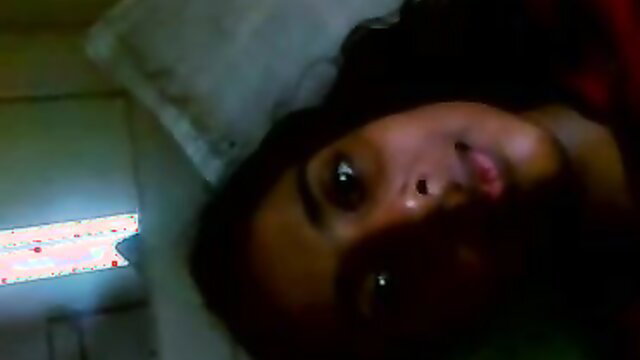 Hot Indian babe lying in bed, seductive gaze, closeup face