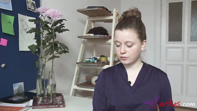 Naughty brunette MILF in purple top smiles seductively at camera