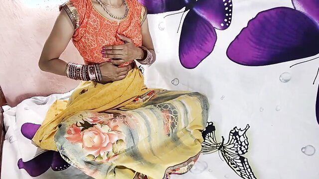 Hot Indian Desi Bhabi in orange saree and jewelry, seductive pose