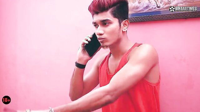Red-haired Indian guy on phone call in tight red tank top