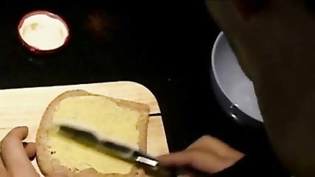 Slave spreads butter on bread in humiliating kinky kitchen tease