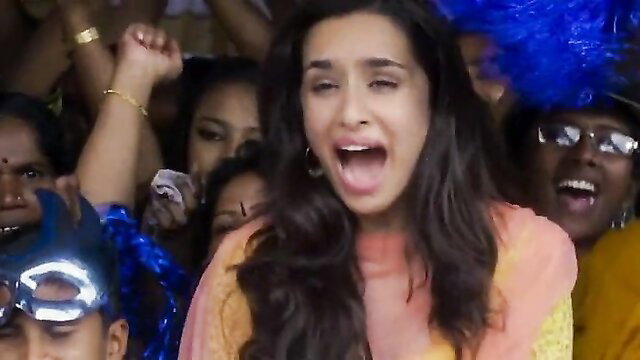 Shraddha Kapoor in vibrant orange top, excited crowd party scene from Baaghi movie
