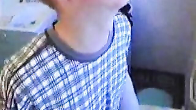 Russian 62yo granny in checkered shirt, neck exposed in kitchen