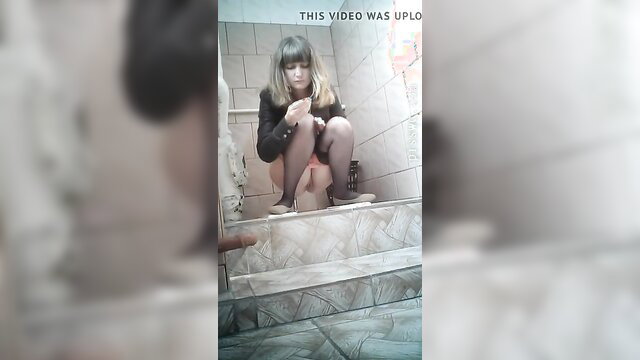 Amateur blonde squats to pee in public toilet, skirt up stockings