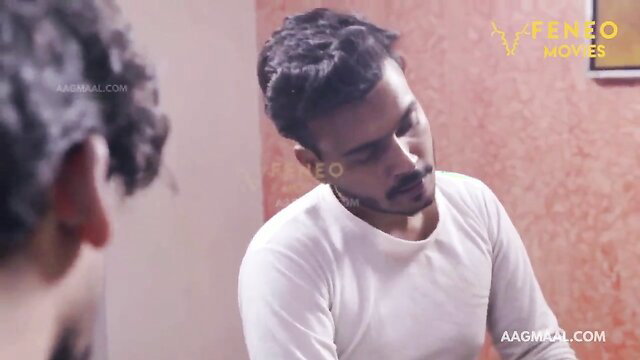 Handsome Indian man in white tee gazes intimately in Feneo short film