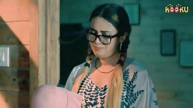 Brunette Indian babe in glasses, pigtails holding pink toy, sexy blouse