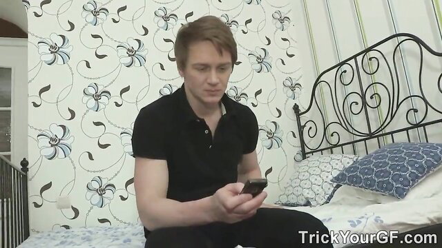 Young redhead Alina in black polo sits on bed texting in revenge porn teaser