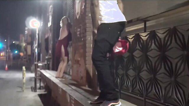 Curvy cougar MILF in red dress with guy outdoors at night