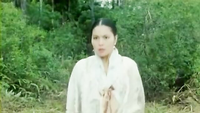 Asian beauty in white dress prays in lush jungle, softcore tease