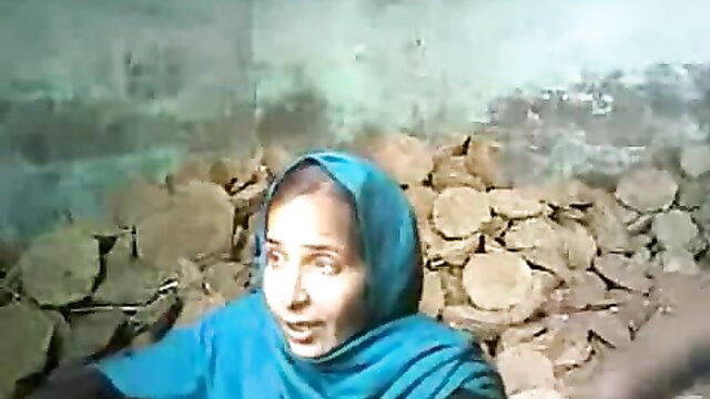 Natural Mumbai babe in blue hijab surrounded by cow dung patties