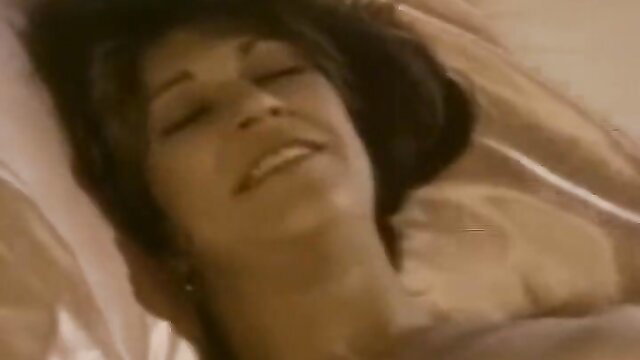 Marilyn Chambers smiling in bed, vintage porn thumbnail