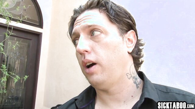 Tattooed man with shocked expression in backyard adult scene
