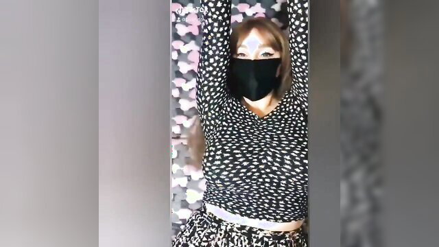 Redhead teen in mask and polka dot top, TikTok tease pose