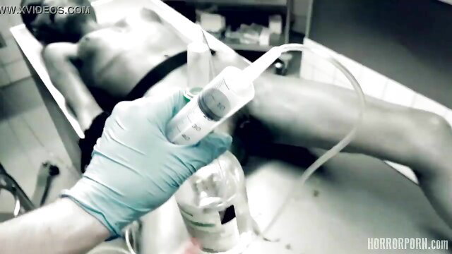 HorrorPorn Roswell UFO: gloved hand injects syringe into nude man's thigh