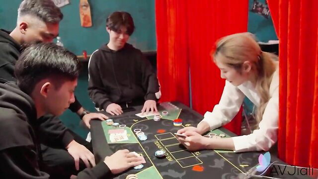 Blonde sexy Taiwanese girl in white blouse at card table with guys