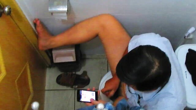 Asian bear man taking dump on toilet holding phone POV
