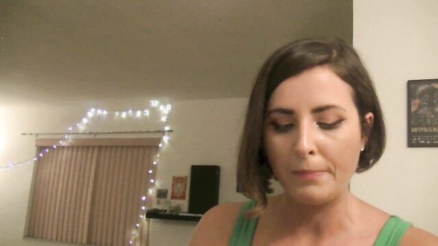 Helena Price chewing and chatting closeup in green tank top