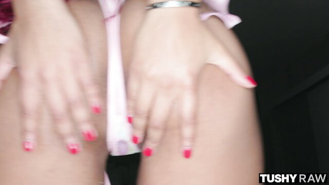 Woman's hands gripping oiled thighs in pink lingerie, Tushy Raw