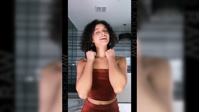 Curvy Latina Dani Diaz in tight red crop top, curly hair up close