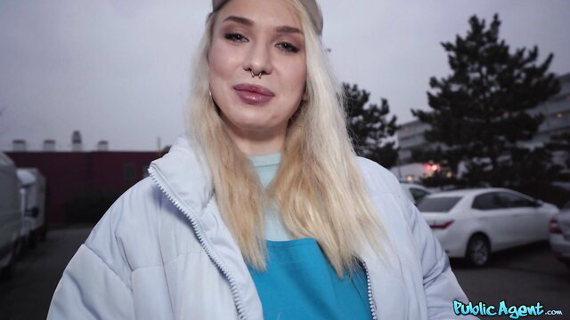 Vera Jarw blonde in public parking lot smiling at camera