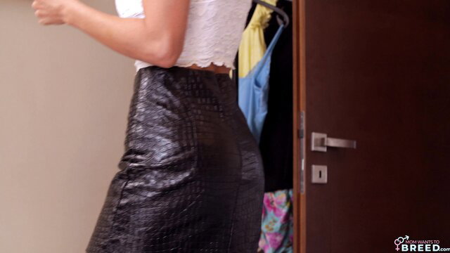 Natalie Grace in tight black leather skirt by closet, hot MILF view