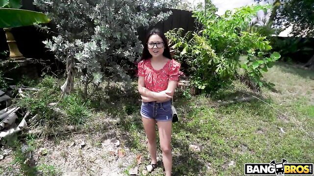 Lulu Chu in red top and denim shorts on BangBros outdoor set