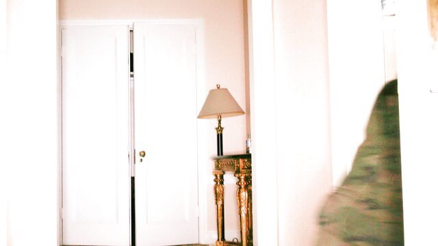 Mia Kay beside white door and lamp in Blacked Raw scene