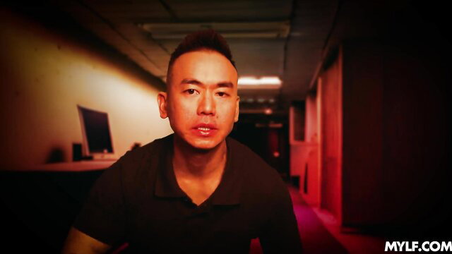 Asian Mylf Suki Sin stares intensely in dark hallway