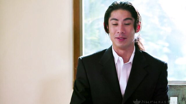 Handsome Asian man in suit with ponytail, Lauren Phillips massage