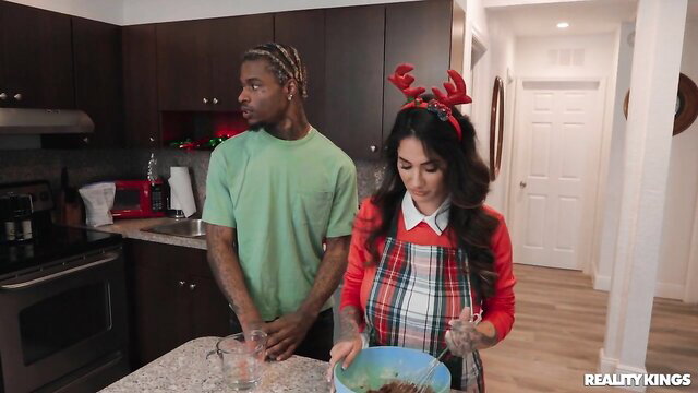 Arabelle Raphael in apron mixes with Valerica Steele & black stud in kitchen