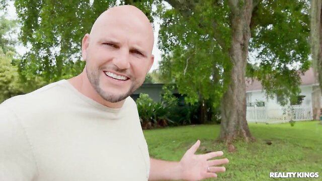 Bald JMac smiles outside in Real MILF Real Estate with Pristine Edge
