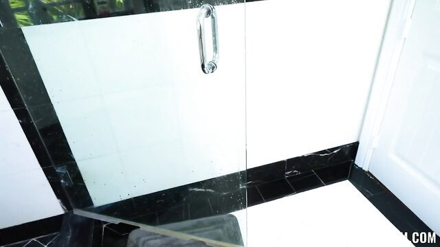 Kate Dee in white cabinet kitchen with black marble floor