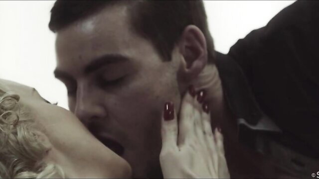 Blonde bombshell passionately kisses man close-up