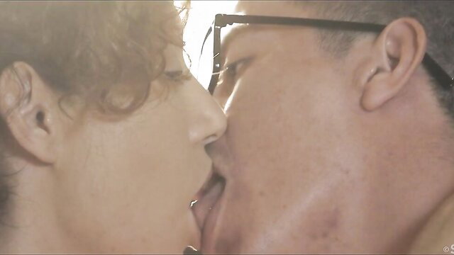 Hot brunette and guy passionately French kissing closeup