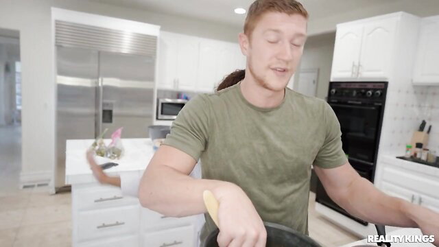 Reality Kings kitchen threesome sneak peek with redhead guy and two babes