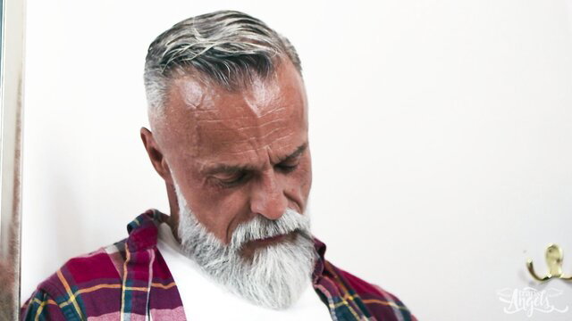 Silver-haired Daddy John with beard in plaid shirt, closeup portrait