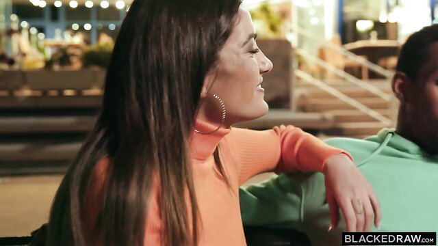 Penelope Cross in orange turtleneck with hung black stud Blacked