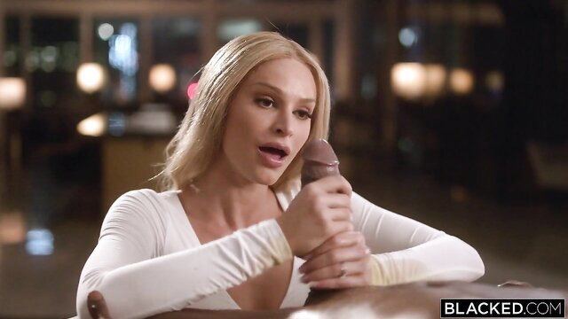 Emma Hix holds big black dildo, blonde tits spilling from white top