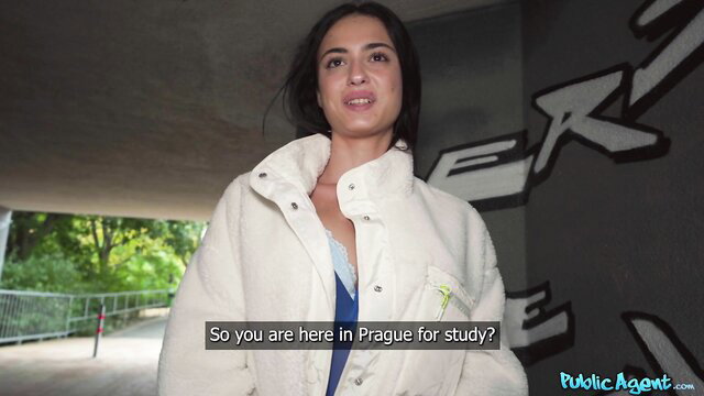 Tattooed Spanish babe in white puffer jacket interviewed in Prague public tunnel