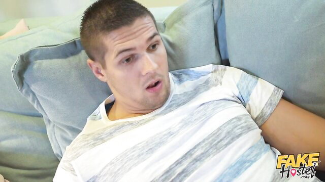 Handsome buzzcut guy shocked on couch in Fake Hostel The Remote Control
