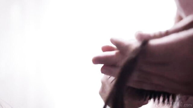 Alison Rey's hands gripping long black hair and brush in taboo tease